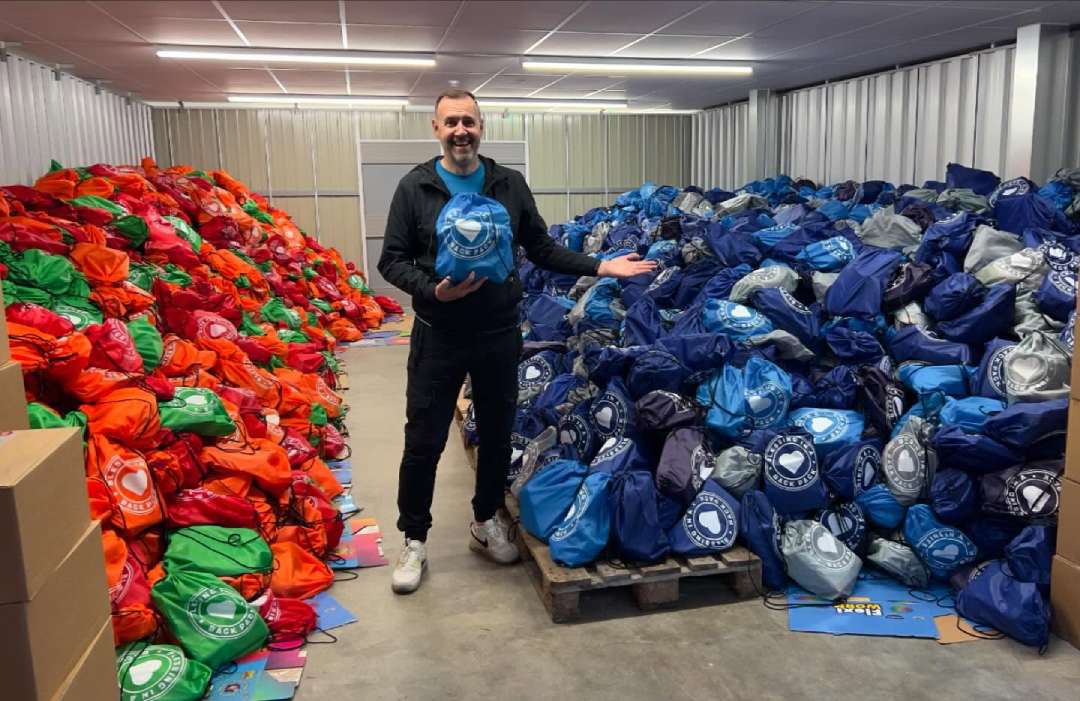 Richard Vernon with lots of filled backpacks ready for distribution