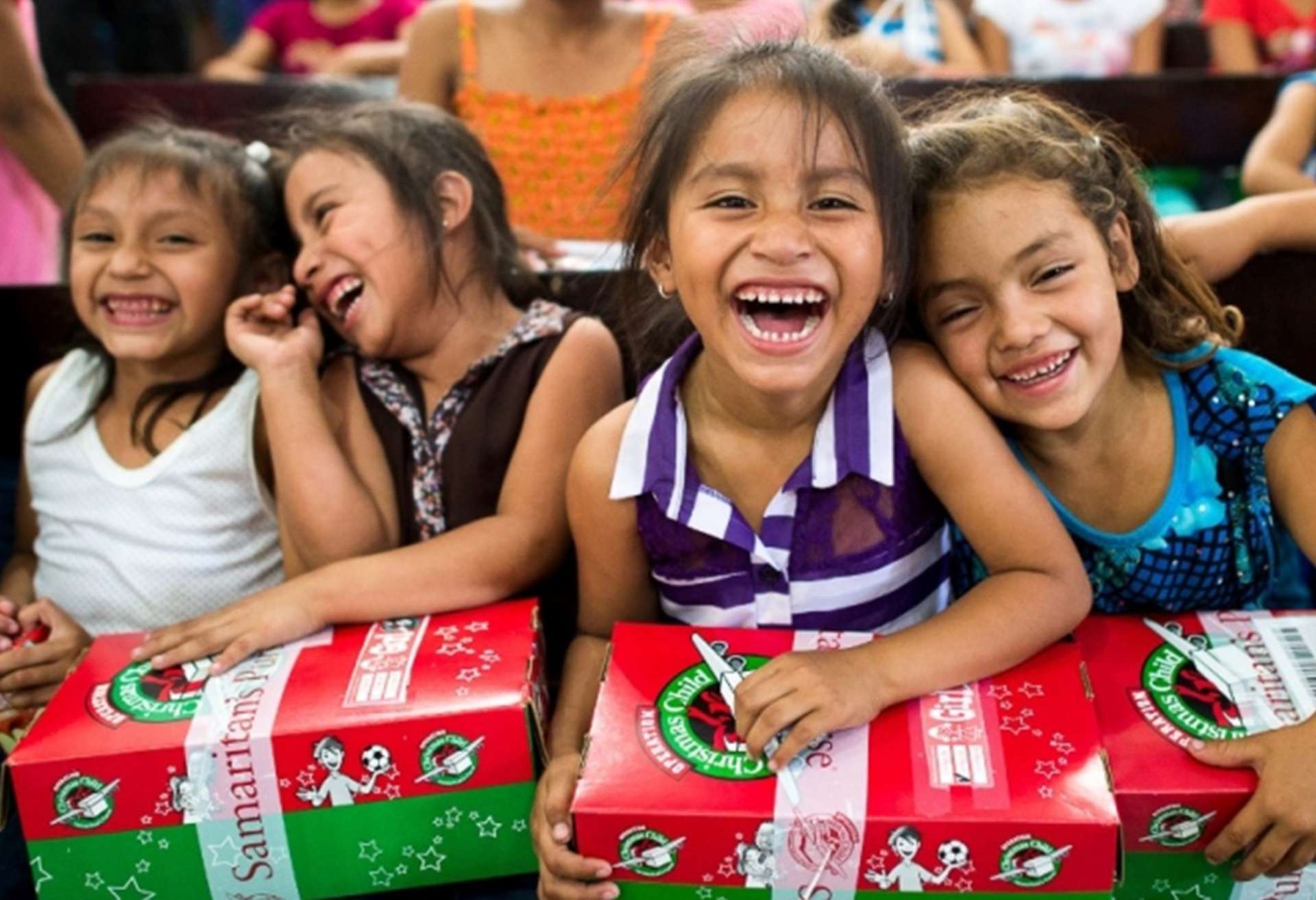 Image showing laughing girls with gift shoeboxes