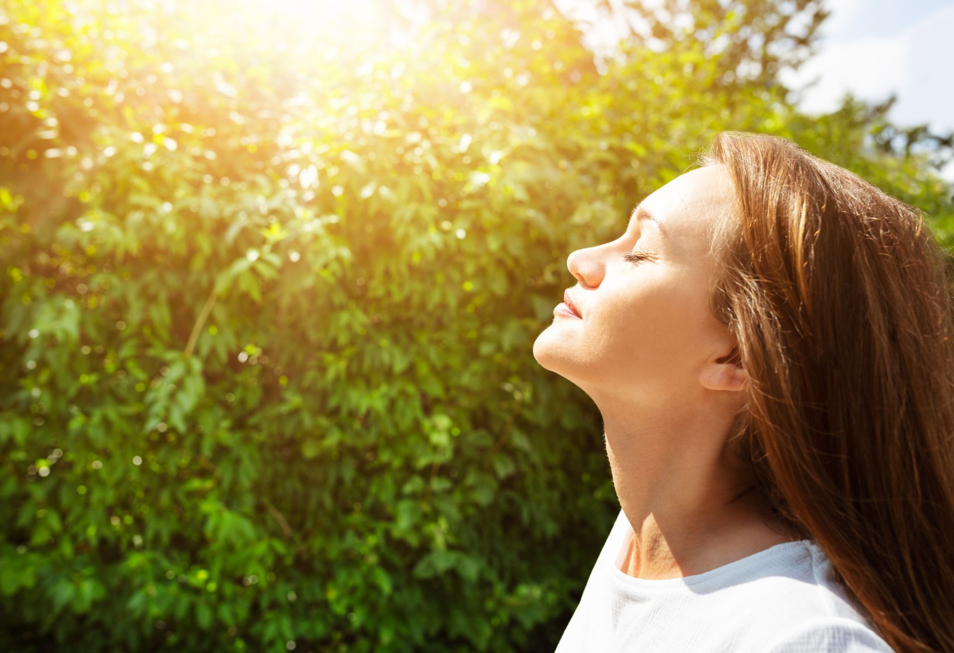 Image of a woman breathing in the sunshine