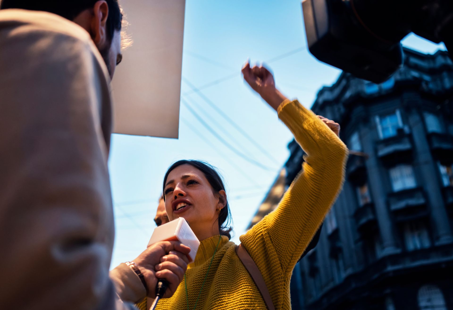 Image of a woman being interviewed at a protest