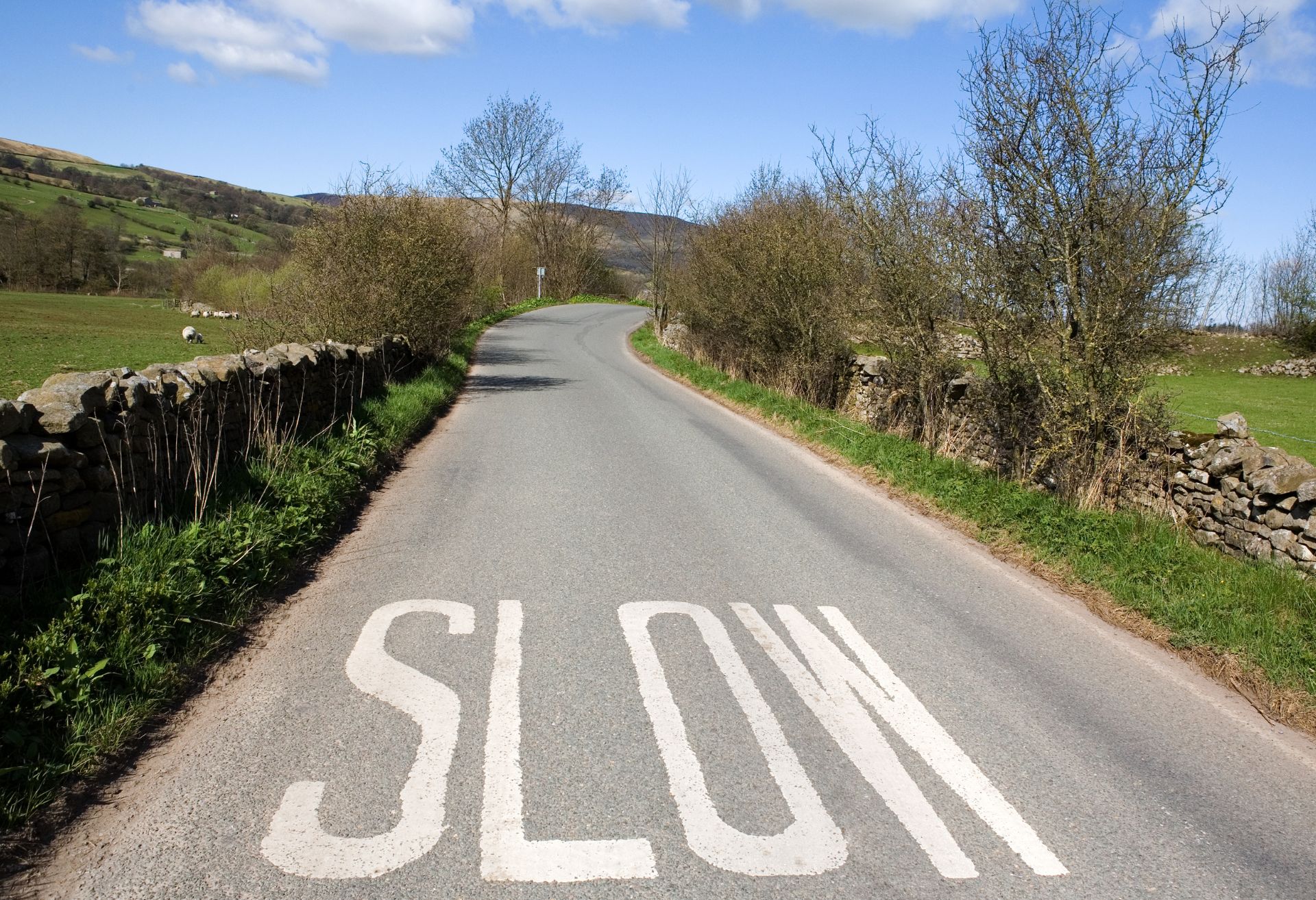 Image of a slow sign painted on the road